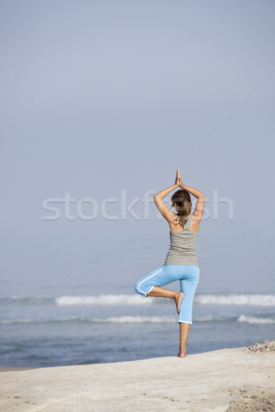 Beautiful young woman with arms open, relaxing on the beach Stock photo © iko