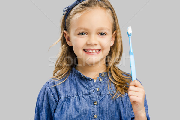 Stock photo: Little girl brushing teeth