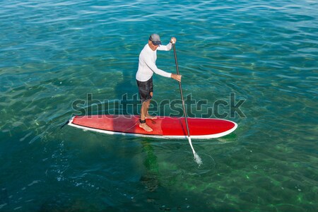 Senior man practicing paddle Stock photo © iko