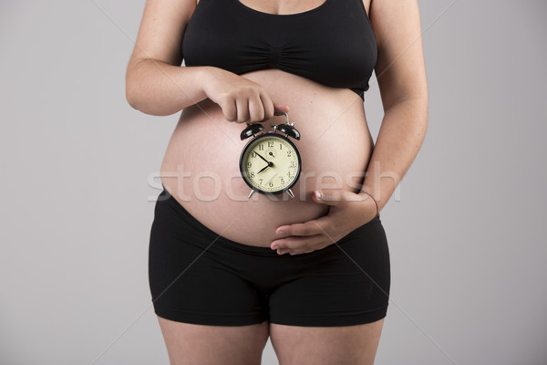 Czasu urodzony kobieta w ciąży brzuch zegar Zdjęcia stock © iko