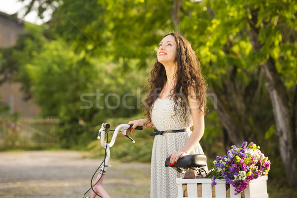 Menina feliz bicicleta belo mulher jovem completo flores silvestres Foto stock © iko