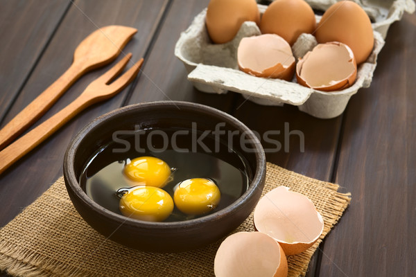 Nyers tojások három rusztikus tál tojás Stock fotó © ildi