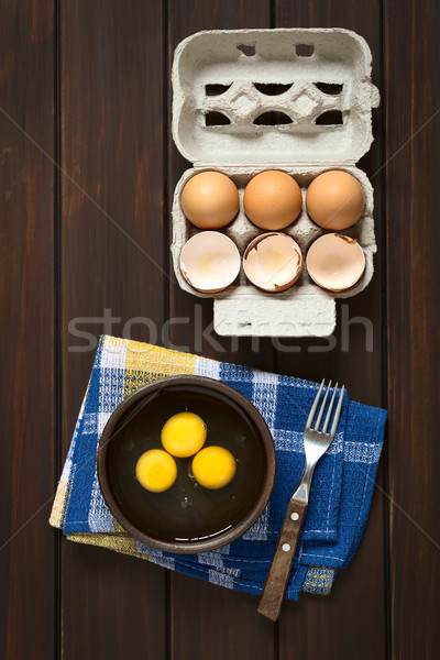 Crudo huevos tiro tres rústico tazón Foto stock © ildi
