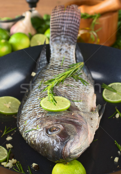Raw Tilapia with Condiments in Frying Pan Stock photo © ildi