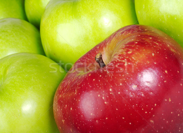 Red Apple in between Green Apples Stock photo © ildi