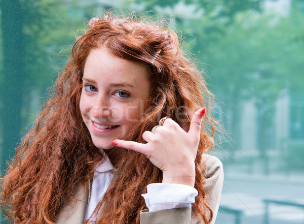 Stock photo: Outdoor portrait young woman talk on a cellular telephone 