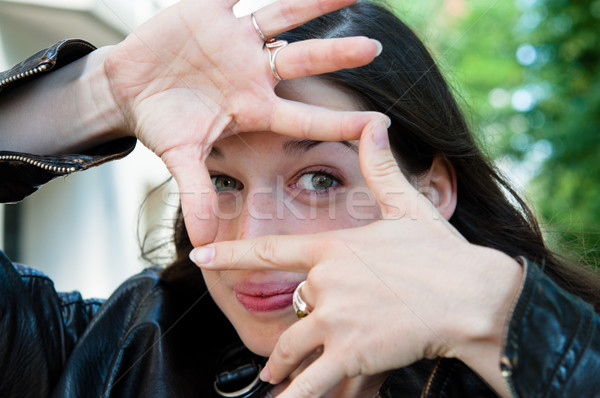 Young woman is focused view in the viewfinder gestures  Stock photo © ilolab