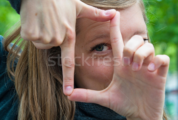 Young woman is focused view in the viewfinder gestures  Stock photo © ilolab