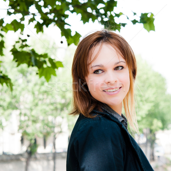beautiful attractive young woman smiling while looking back  Stock photo © ilolab