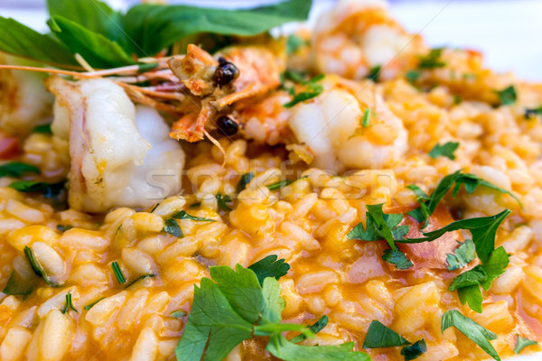 Tasty risotto with Shrimp, fresh herbs vegetables on a white pla Stock photo © ilolab