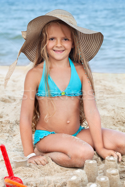 Happy child building sand castles on the beach Stock photo © ilona75
