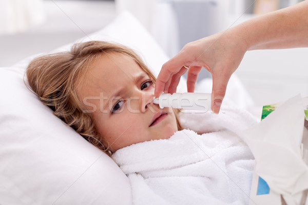 Little girl with bad cold using nasal spray Stock photo © ilona75