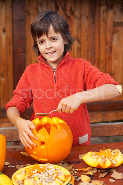 Boy carving his jack-o-lantern Stock photo © ilona75