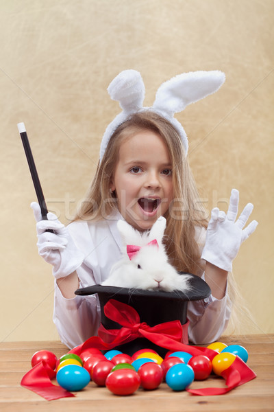 Little magician girl conjuring easter items Stock photo © ilona75