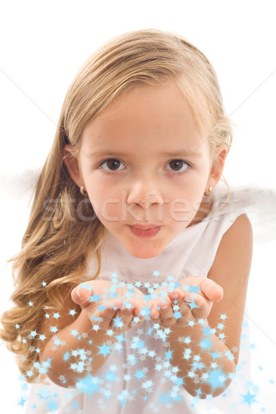 Stock photo: Little girl blowing stars from her palms