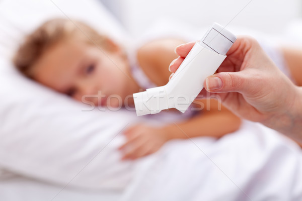 Sick kid with inhaler in foreground Stock photo © ilona75