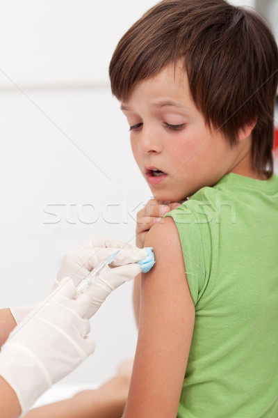 Worried boy getting an injection Stock photo © ilona75