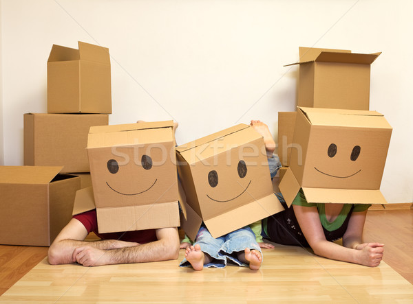 Smiley moving family - couple with a kid Stock photo © ilona75