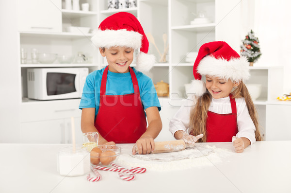 Happy christmas kids stretching the cookie dough Stock photo © ilona75
