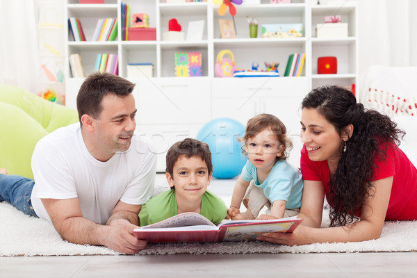 Stock photo: Young family story time with the kids