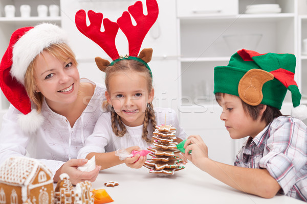 Woman and her kids decorating christmas cookies Stock photo © ilona75