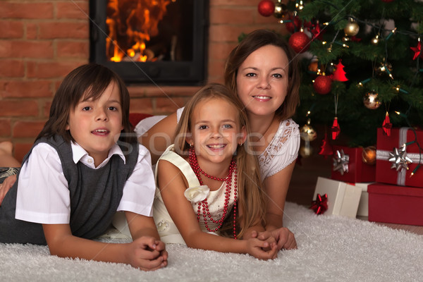 Family laying by the fire on Christmas eve Stock photo © ilona75