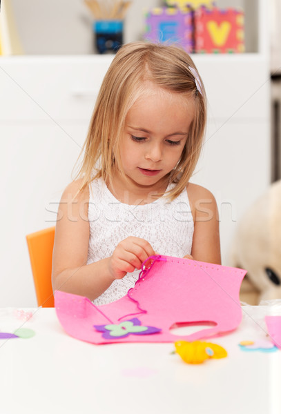 Little girl working on a crafting project - doing some needlewor Stock photo © ilona75