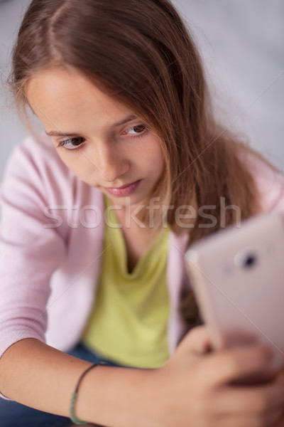 Young teenager girl trying to take a good selfie Stock photo © ilona75