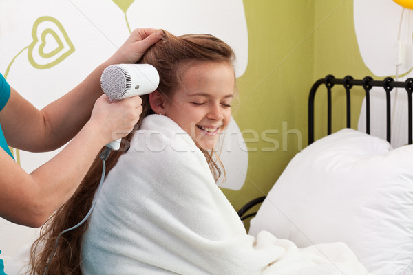 Mother drying her little girl's hair after bath Stock photo © ilona75