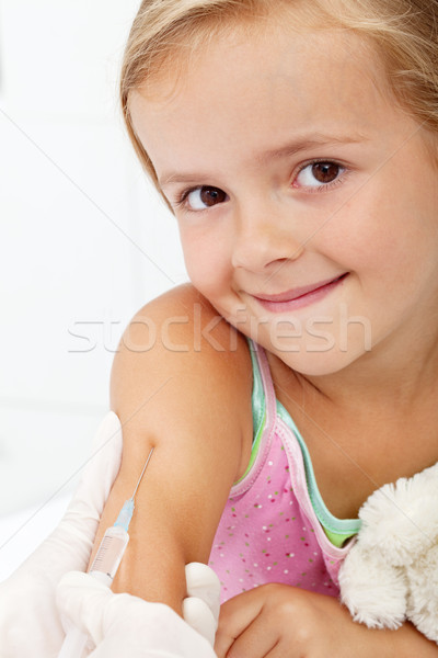 Smiling child receiving vaccine Stock photo © ilona75