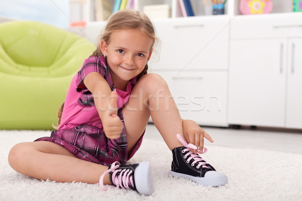 Little girl learning how to tie her shoes Stock photo © ilona75