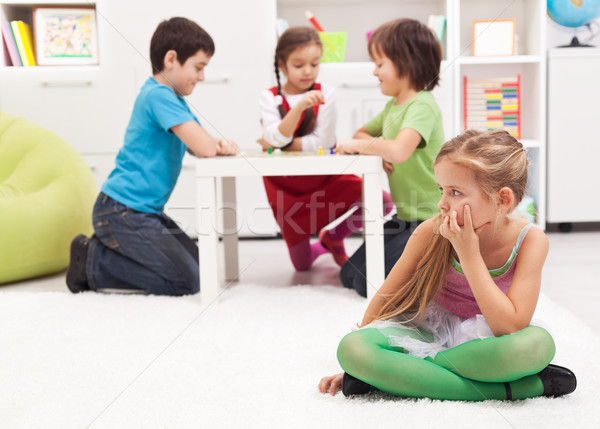 Little girl sitting apart - feeling excluded by the others Stock photo © ilona75