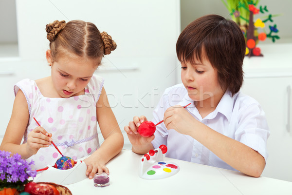 Boy and girl painting easter eggs Stock photo © ilona75