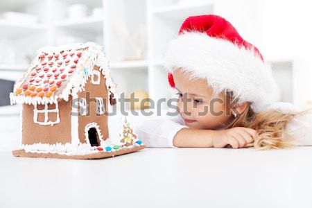 Kids with funny christmas hats and gingerbread house Stock photo © ilona75
