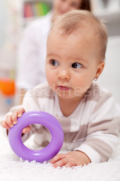Stock photo: Baby girl with plastic toy
