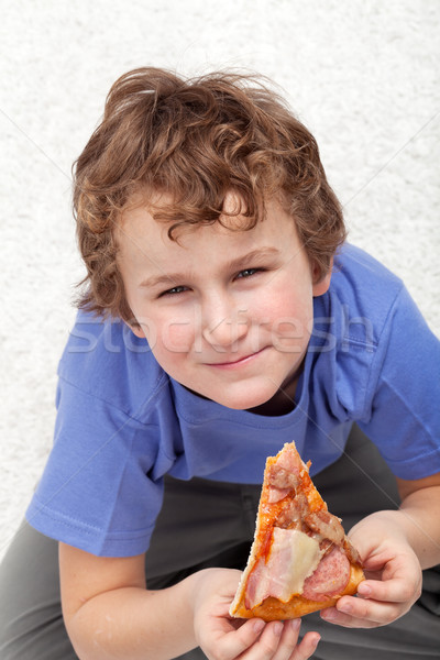 Boy with a slice of pizza Stock photo © ilona75