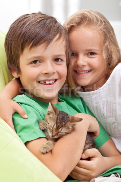 Happy kids with their new pet - a little kitten Stock photo © ilona75