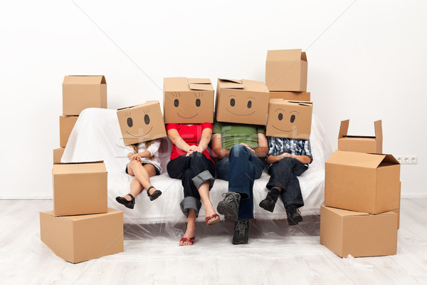 幸福的家庭 新居 一起 坐在 沙發 商業照片 © ilona75