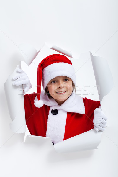 Opening the holidays season - boy looking through jagged edge ho Stock photo © ilona75