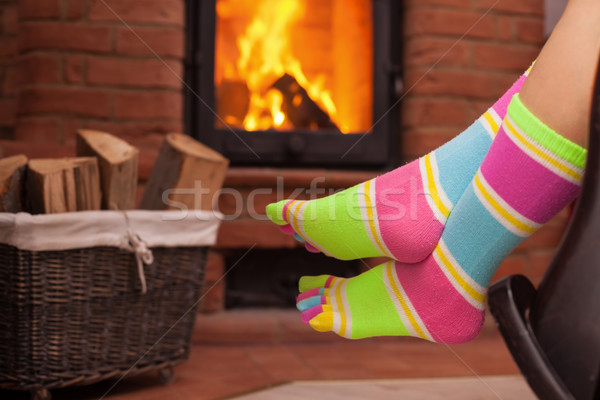 Detail of woman relaxing in front of fireplace Stock photo © ilona75