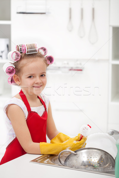 Little girl with big curls doing the dishes Stock photo © ilona75