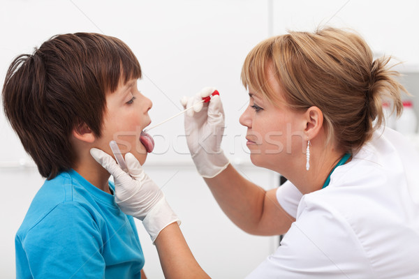 Health professional taking saliva sample from little boy Stock photo © ilona75