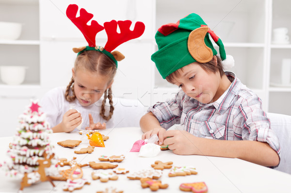 Santa little helpers decorating gingerbread cookies Stock photo © ilona75