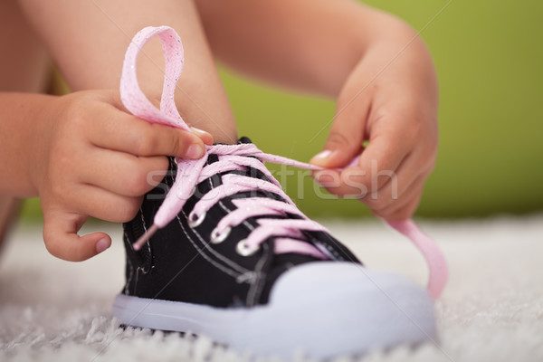 Young girl hands tie shoe laces-shallow depth of field Stock photo © ilona75