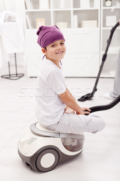 Young boy sitting on vacuum cleaner Stock photo © ilona75