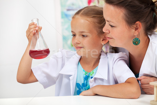 Young student girl in chemistry class with her teacher Stock photo © ilona75