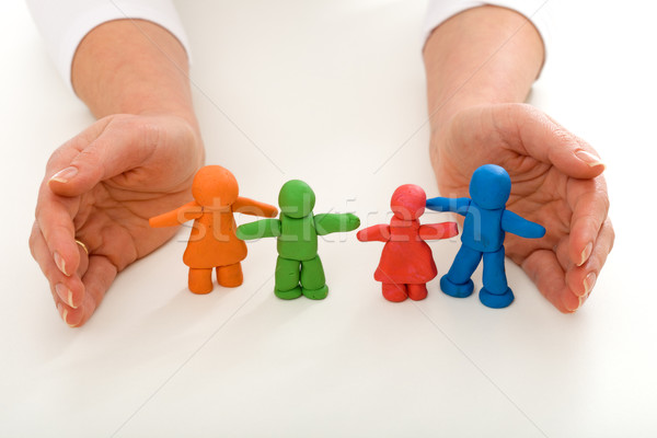 Woman hands protecting clay people family Stock photo © ilona75