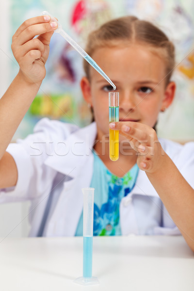 Little girl experimenting in chemistry class Stock photo © ilona75