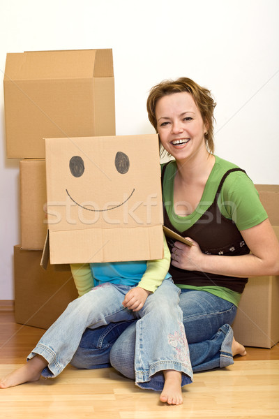 Little girl and woman having fun moving to a new home Stock photo © ilona75