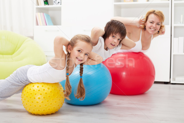 Happy healthy family exercising Stock photo © ilona75